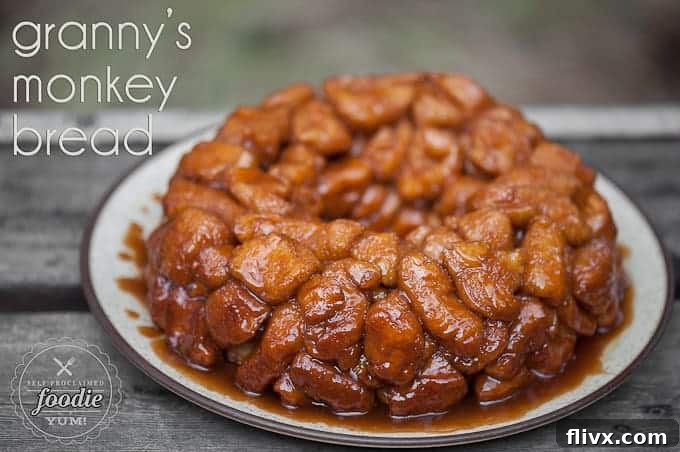 Granny's Monkey Bread Recipe, golden-brown and gooey, dusted with powdered sugar.