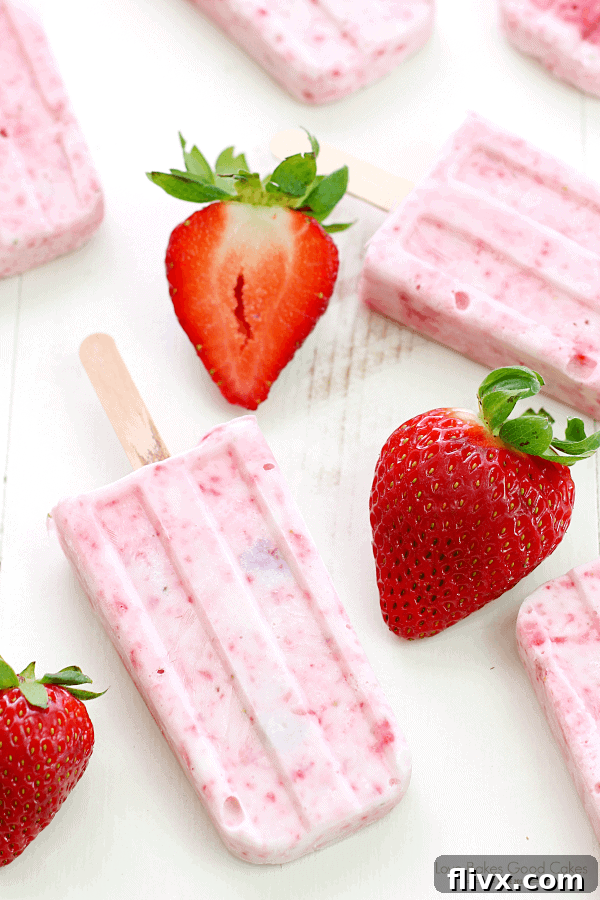 Homemade Strawberry-Yogurt Popsicles, vibrant pink and refreshing.