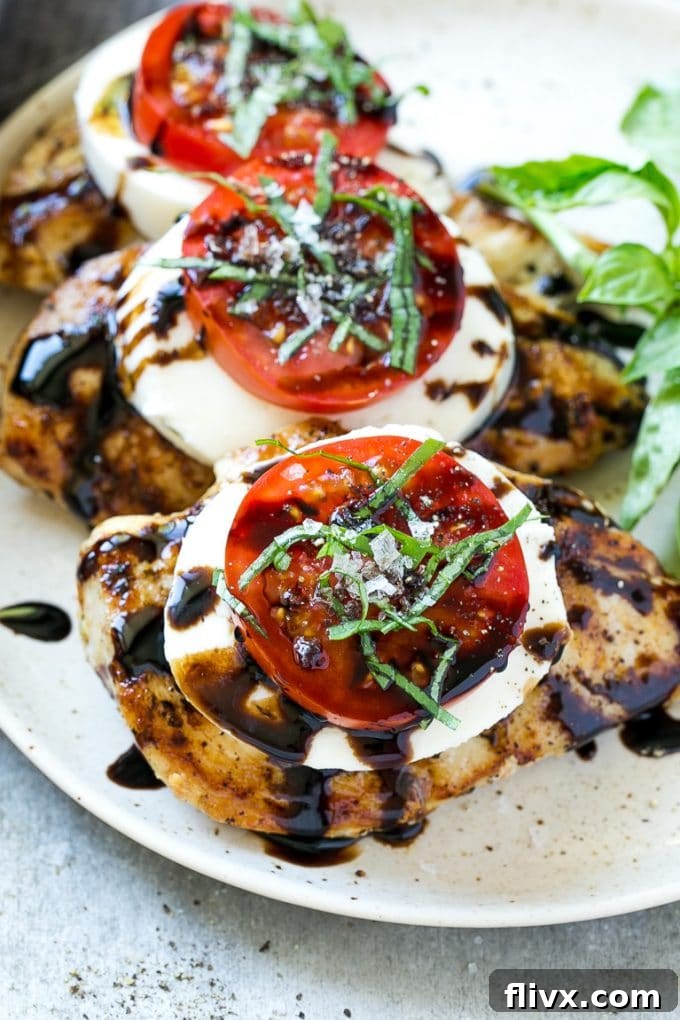Chicken Caprese, a dish with grilled chicken topped with fresh mozzarella, ripe tomatoes, basil, and a balsamic reduction.