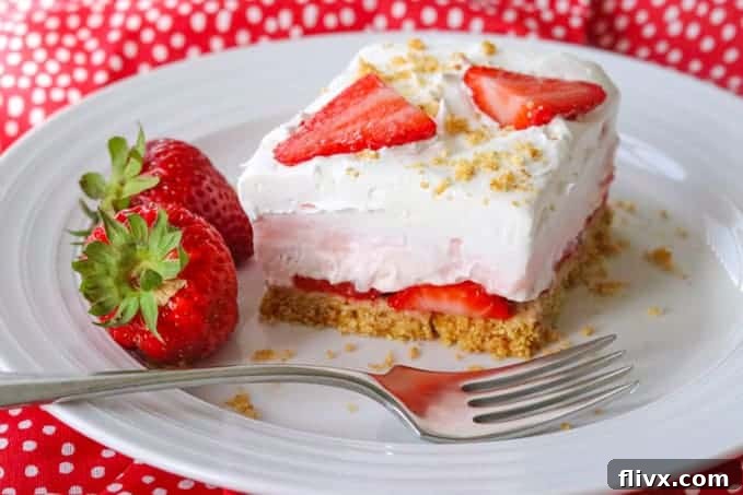 Strawberry Cheesecake Dream Bars featuring a graham cracker crust, a creamy filling, and fresh strawberry topping.
