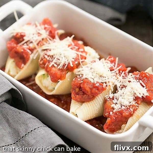 Spinach Stuffed Pasta Shells arranged neatly in a casserole dish, topped with sauce, ready for the oven.