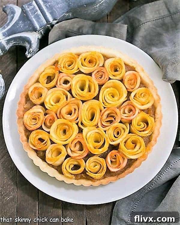 Overhead view of Rose Apple Tart on a white ceramic plate, beautifully arranged.