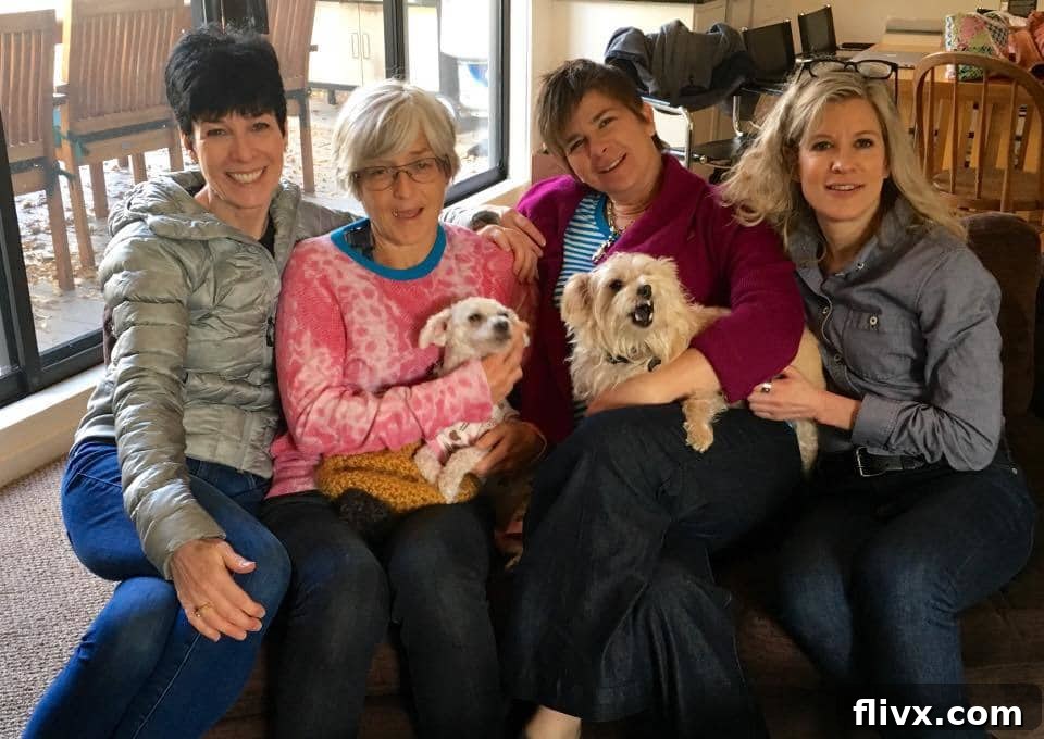 Four sisters posing together in Aspen, Colorado, with mountains and a river in the background.