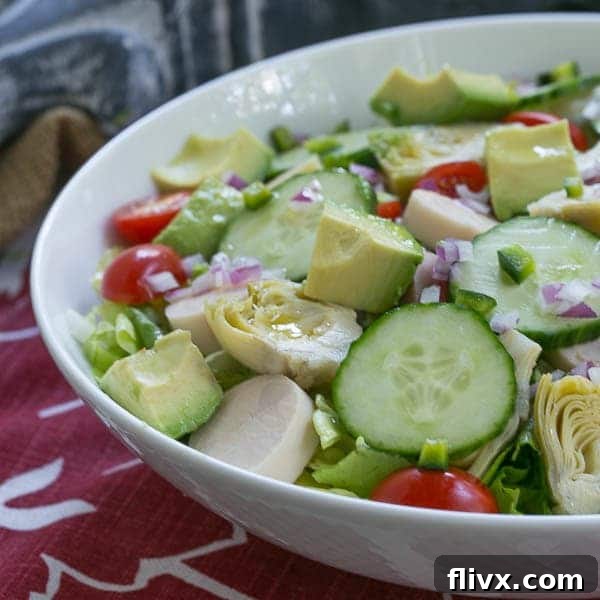 Hearts of Palm, Artichoke, Avocado and Butter Lettuce Salad in a white serving bowl