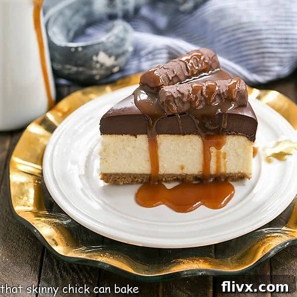 A slice of Chocolate Caramel Twix Cheesecake, generously drizzled with golden caramel sauce, showcasing its impressive layers and inviting texture.