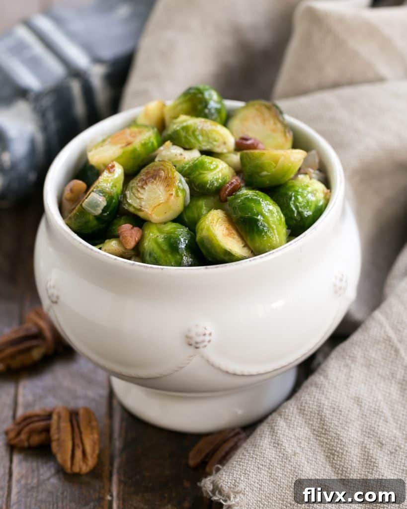A white bowl of Brussels sprouts, perfectly sautéed