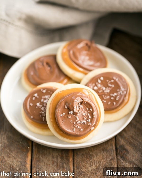 Exquisite Chocolate Caramel Shortbread Cookies elegantly arranged on a round white plate, highlighting their perfect layers of golden shortbread, shimmering caramel, and glossy chocolate.