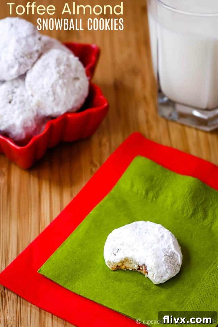 Delicate Toffee Almond Snowballs, dusted with powdered sugar, offering a buttery, nutty, and subtly sweet crunch for a festive treat.