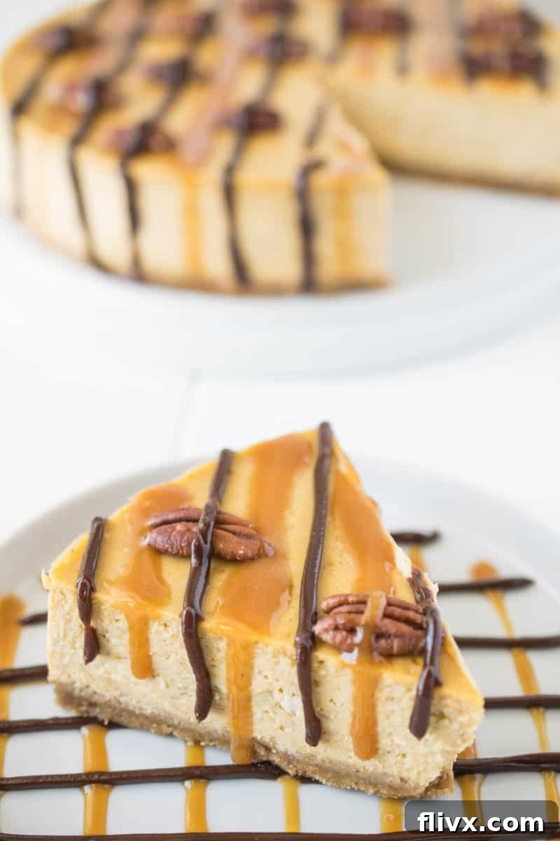 Luxurious Pumpkin Turtle Cheesecake, adorned with caramel, pecans, and chocolate drizzles, blending classic fall flavors with decadent cheesecake.