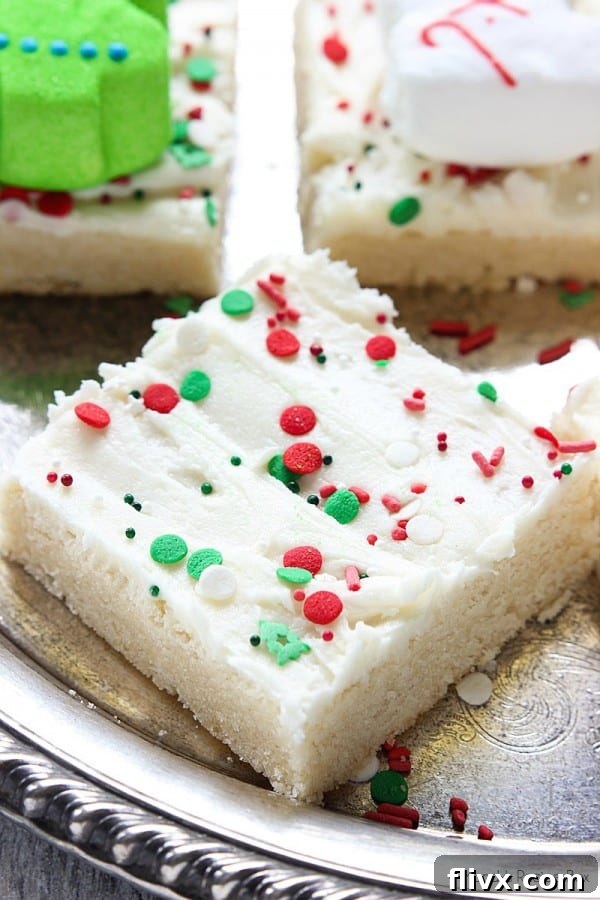 Delightful Eggnog Sugar Cookie Bars, topped with creamy eggnog frosting and a sprinkle of nutmeg, offering a festive and easy-to-share treat.