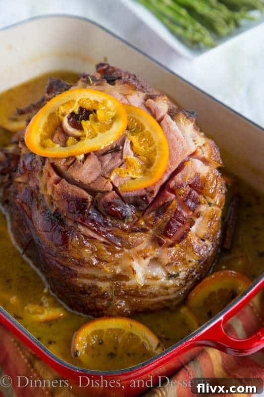 A beautifully roasted Tangerine Glazed Ham, glistening with a sweet and citrusy glaze, making a perfect centerpiece for any holiday meal.