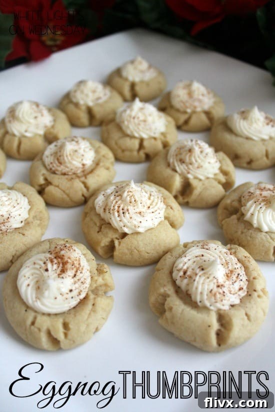 Festive Eggnog Thumbprint Cookies, featuring a delicate cookie base with a rich eggnog-flavored filling, perfect for holiday celebrations.