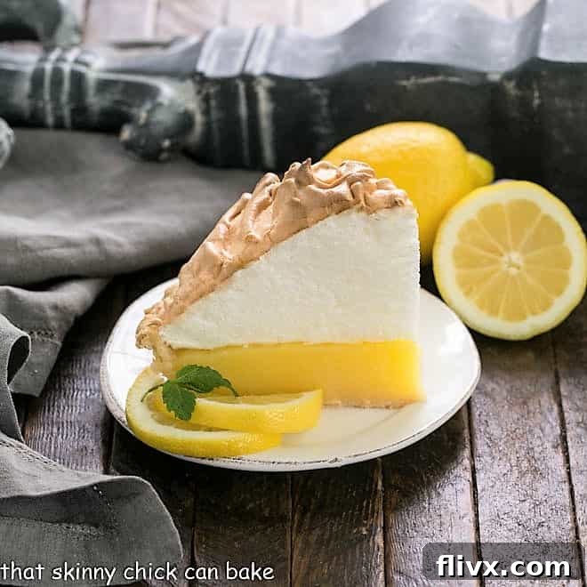 Tall and fluffy Lemon Meringue Pie with a peak of golden-brown meringue topping a zesty lemon custard.