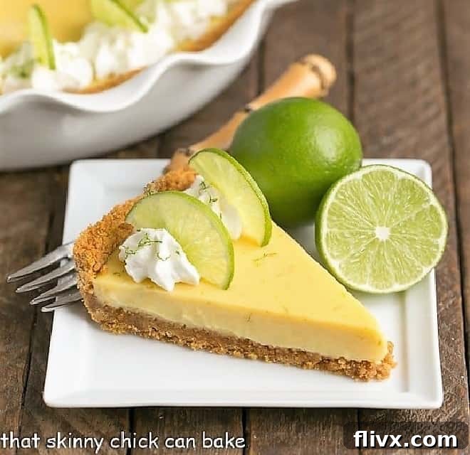 Tangy Key Lime Pie with a golden graham cracker crust, topped with fresh lime slices and whipped cream.