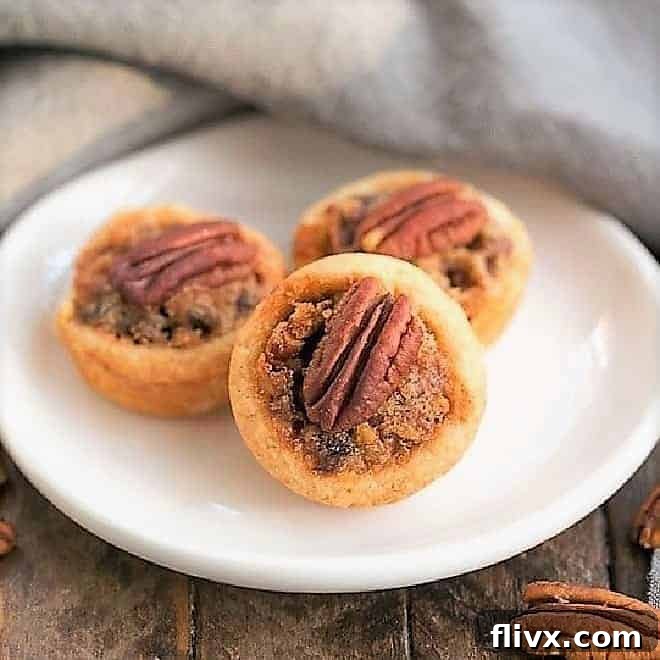 Pecan Tassies on a small white oval plate, ready to be served.