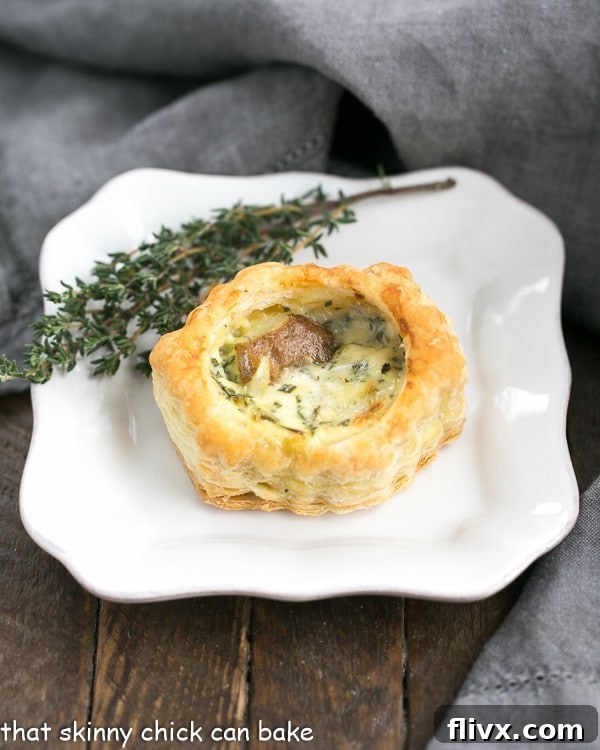 Potato Blue Cheese Tartlets are an easy, elegant and hearty appetizer! One Potato Blue Cheese Tartlet on an appetizer plate.