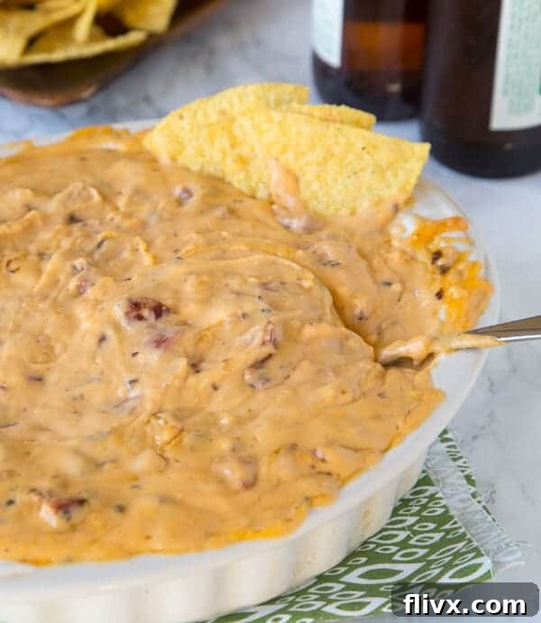 Creamy Cheddar Brat Cheese Dip with pretzels for dipping.