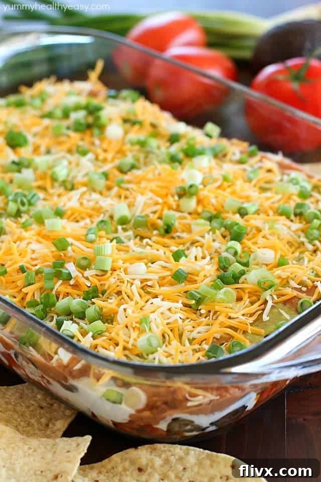 Colorful 7 Layer Bean Dip in a clear dish.