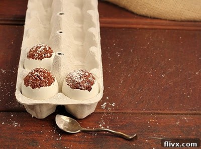 3 eggs in a ceramic crate with tops removed showing brownie eggs