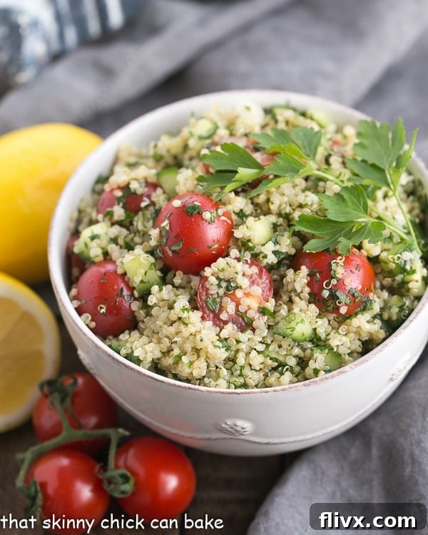 White bowl of Quinoa Tabbouleh. A classic Middle Eastern salad updated with the addition of the tasty superfood, quinoa. This Tabbouleh Recipe is sporting a lot of green, making it a healthy option for the St. Patrick’s Day dinner table.