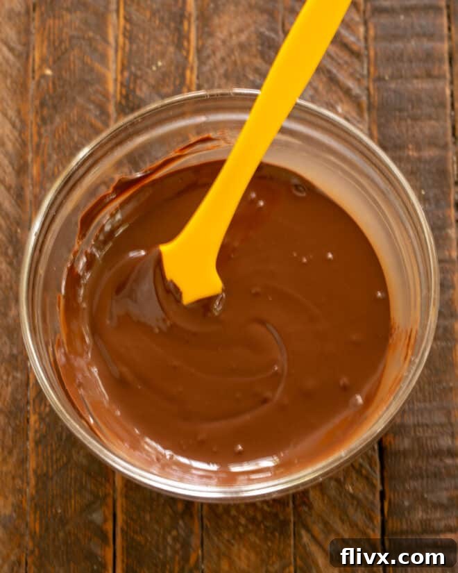 Melted chocolate cooling to lukewarm temperature.