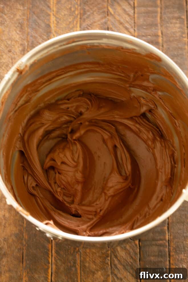 Smooth and blended chocolate frosting in a bowl.