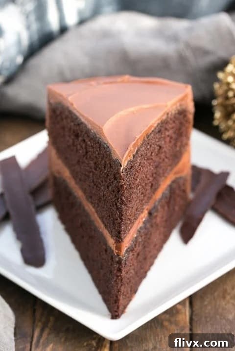A beautifully frosted chocolate mayonnaise cake with one slice removed, ready to be served.