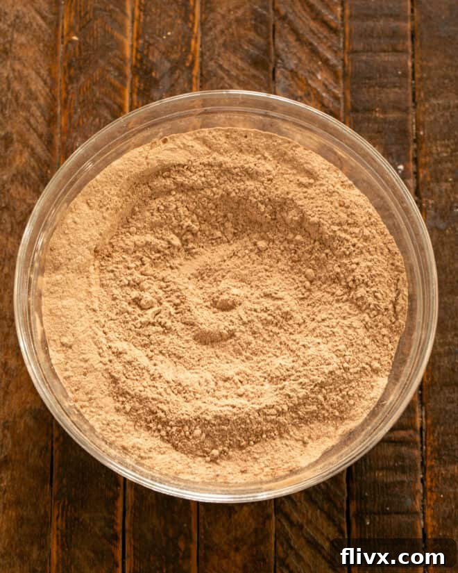 Dry ingredients for chocolate mayonnaise cake being whisked together in a bowl.