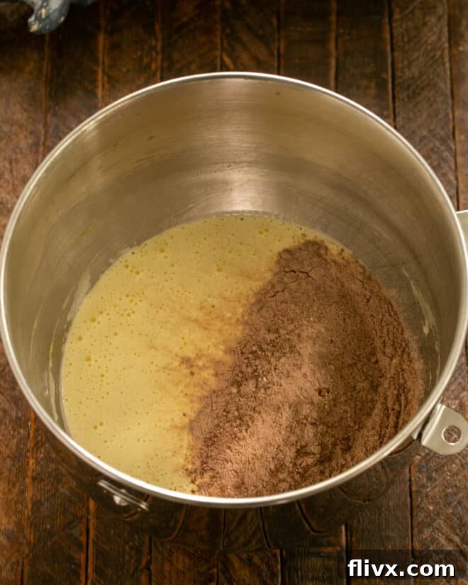 Alternating addition of dry ingredients and coffee to the wet batter.