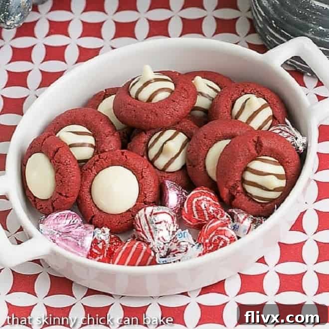 Festive red velvet thumbprint cookies with a cream cheese filling, ideal for Valentine's Day.