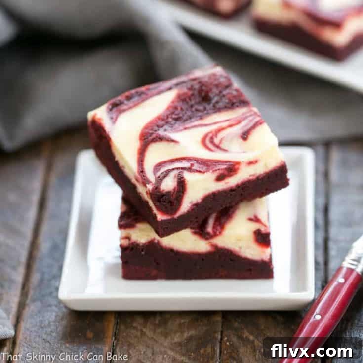 Rich red velvet brownies with a beautiful swirled cheesecake topping.
