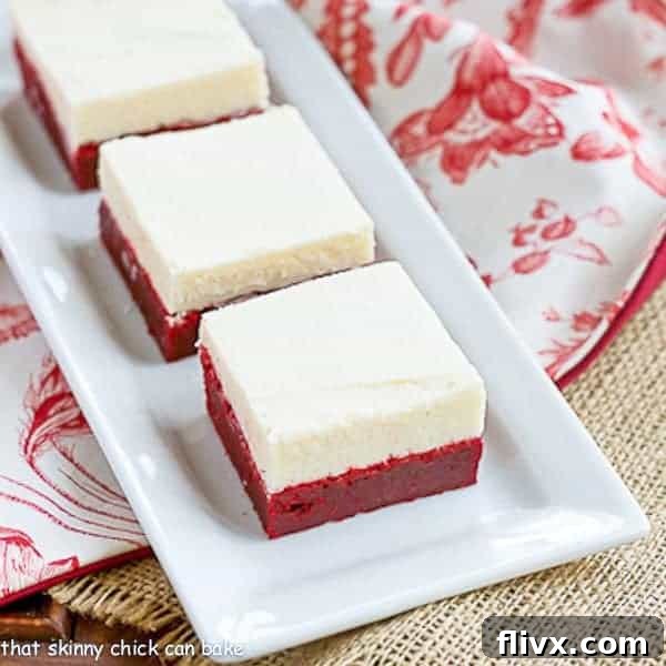 Irresistible red velvet brownies topped with a thick layer of white chocolate icing.