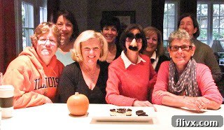 A cheerful group of friends gathered around a table, enjoying good company and delicious food, emblematic of the joy that shared desserts bring.