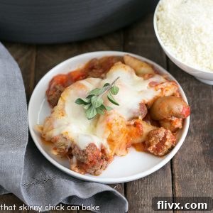 Overhead view of a small white plate with a single serving of Cavatini Supreme, garnished with a fresh herb sprig.