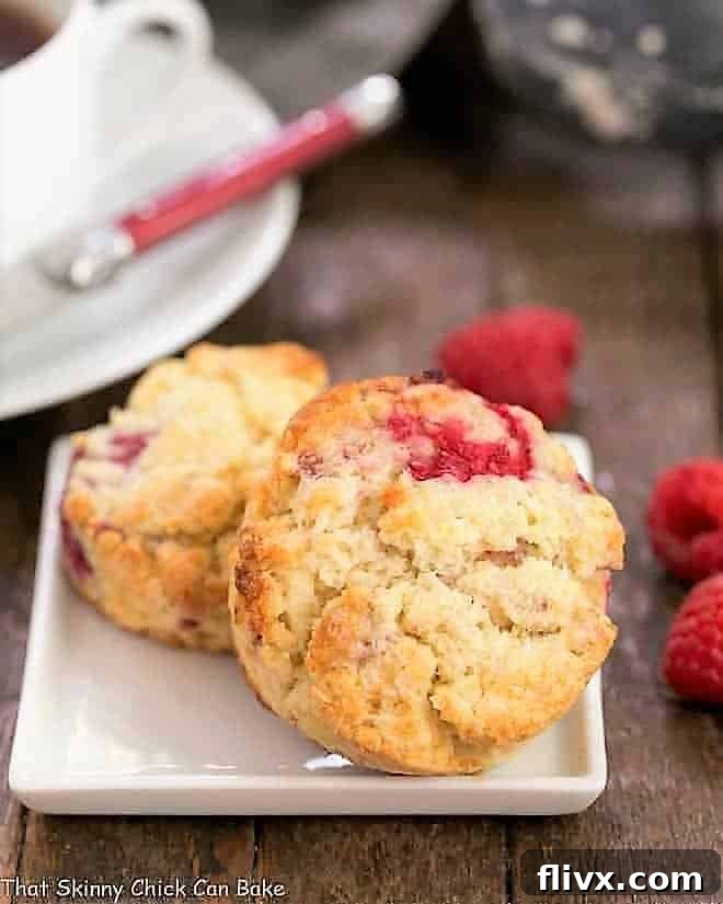 Beautifully baked Raspberry Cream Scones on a square white plate, ready to be served.