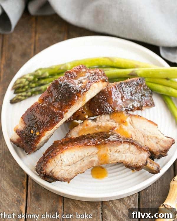 Overhead view of glistening Apricot Glazed Baby Back Ribs arranged neatly on a white plate, ready to be served