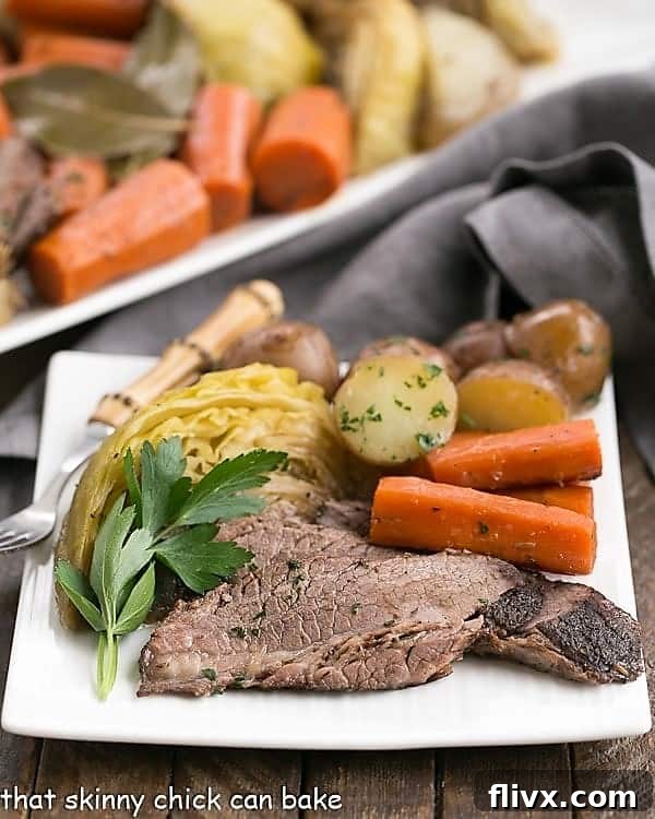 A beautifully plated Irish Braised Corned Beef and Cabbage dinner, showcasing tender beef slices, vibrant cabbage, carrots, and potatoes, ready to be enjoyed.