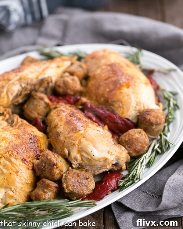 Chicken Scarpariello with Sausage on a platter garnished with fresh rosemary. A perfect Italian-American one-pan dish.