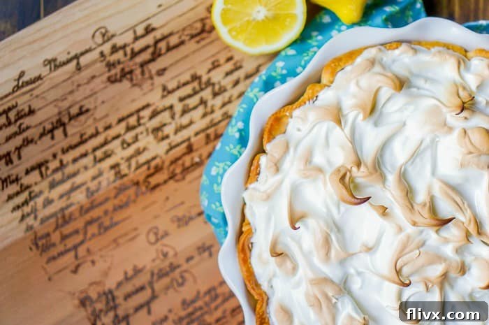 A classic lemon meringue pie with a tall, golden-brown meringue topping.