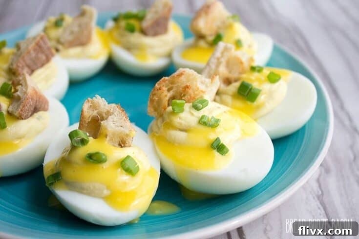 Deviled eggs benedict, a creative fusion of two classic dishes, garnished beautifully.