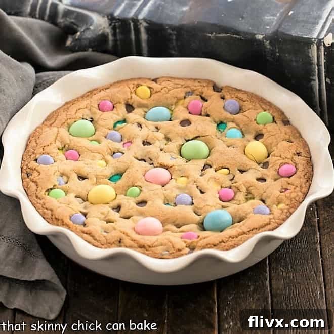 A festive Easter cookie cake topped with colorful Easter candies and chocolate chips.