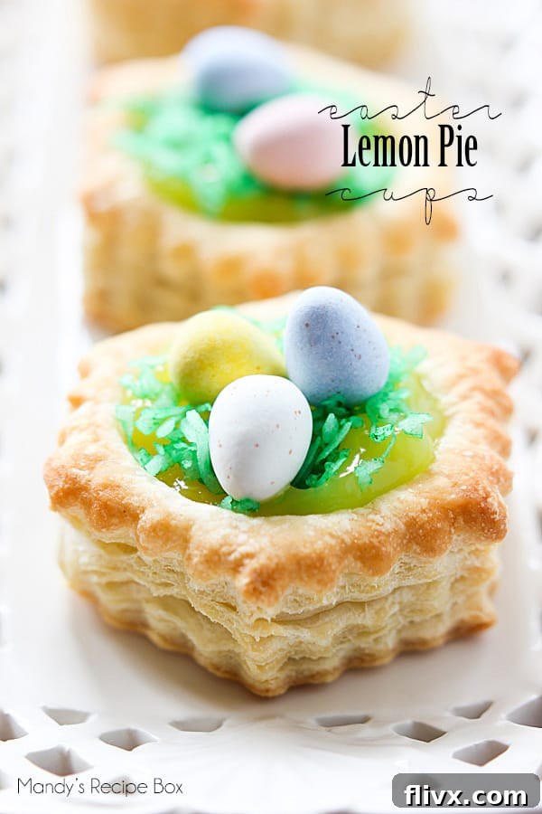 Individual Easter lemon pie cups, garnished with whipped cream and lemon zest.