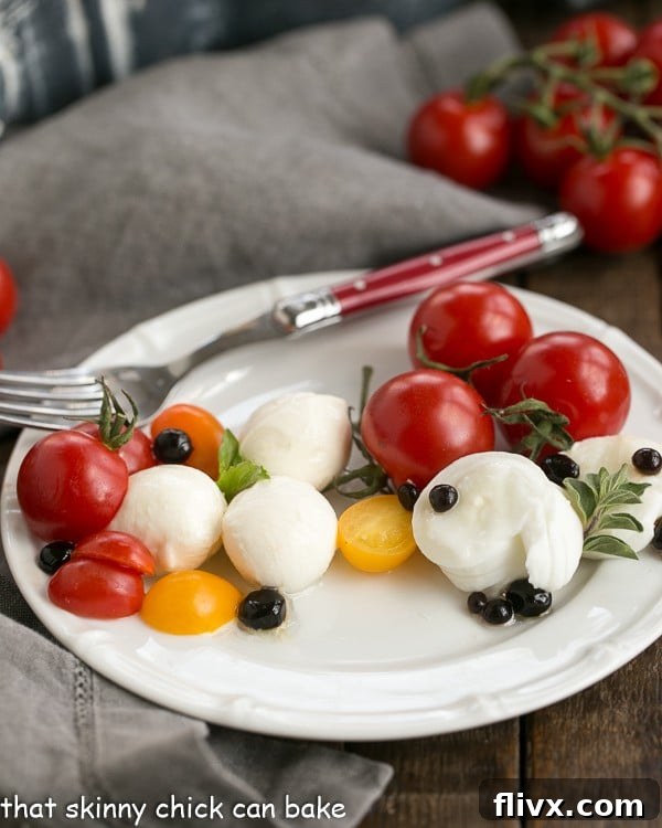 A close-up side view of a vibrant Burrata Caprese Salad on a white plate, showcasing the creamy burrata, red tomatoes, green basil, and dark balsamic pearls, ready to be enjoyed with a fork.