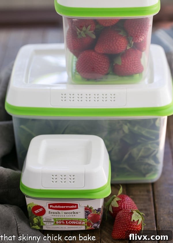 Strawberry Bacon Brie Salad ingredients, including fresh strawberries, crispy bacon, and creamy brie, neatly organized in plastic produce saver containers.