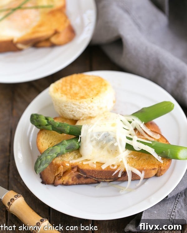 Asparagus & Egg Caps 2 Asparagus topped eggs with hats on a white ceramic plate