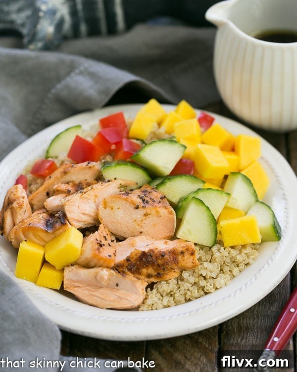 Vibrant Caribbean Salmon Quinoa Salad on a white plate, showcasing salmon, quinoa, mango, and fresh vegetables