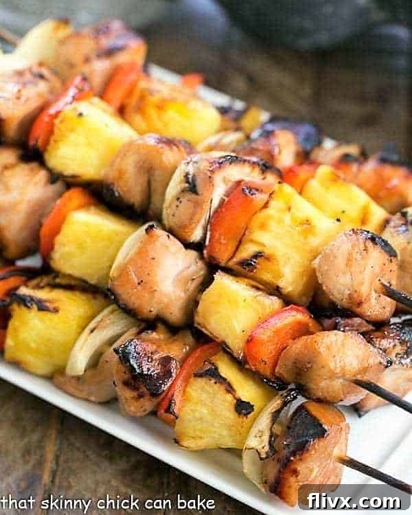Skewered Honey Glazed Chicken Kabobs on a white platter, ready to be served.