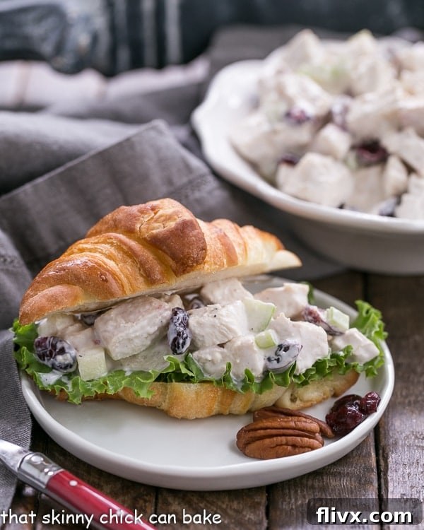 Delightful Cranberry Pecan Chicken Salad for a Crowd, elegantly presented on a golden mini croissant – perfect for any festive gathering or casual meal.