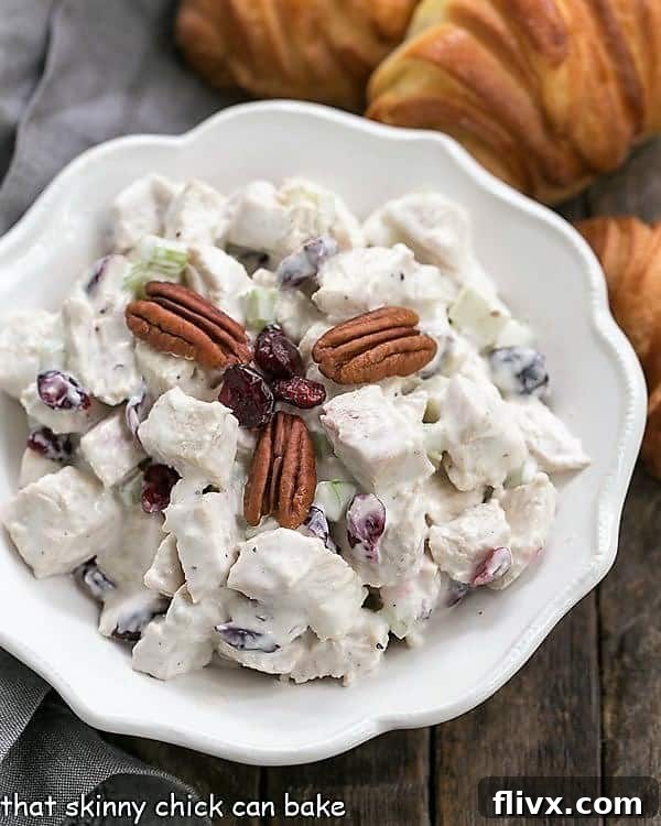 A generously sized serving bowl filled with a fresh batch of Cranberry Pecan Chicken Salad, ready to be enjoyed – perfect for any gathering.