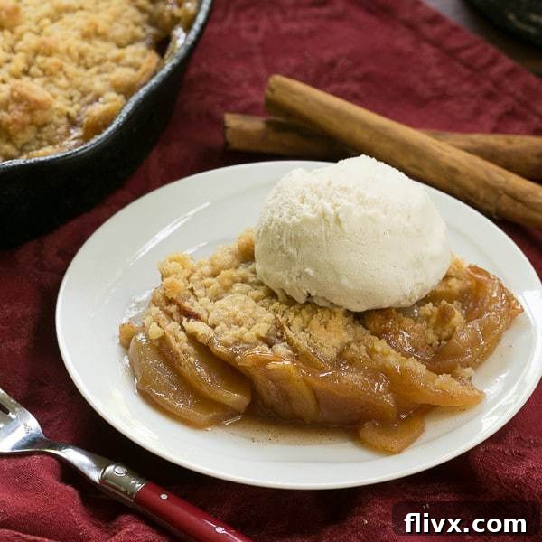 Grilled Apple Crisp, golden brown and bubbly, served in a cast iron skillet.
